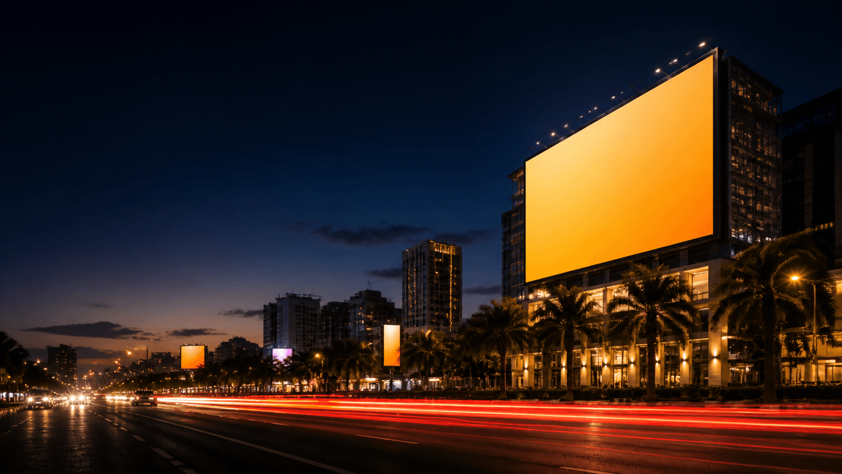Illuminated premium billboard overlooking a busy city boulevard at night